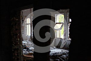 Abandoned room filled with debris and an open window