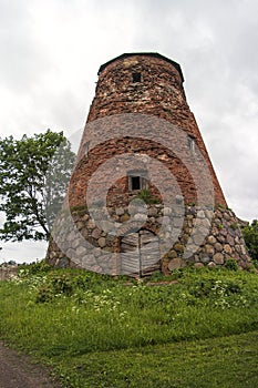 Abandoned ruin of old windmill tower near the city.