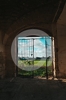 Abandoned Ruin in Southern Italy with Open Gate and Scenic Italian Landscape Beyond