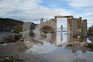 Abandoned Ruin with Woman in Doorway at Bay of Firopotamos in Mi