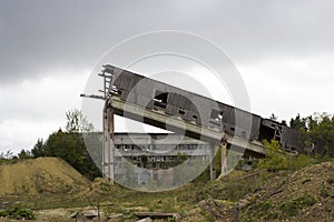 abandoned ruined building. concrete walls with broken windows and a lift, industrial buildings. victory of nature over