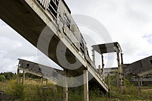 abandoned ruined building. concrete walls with broken windows and a lift, industrial buildings. victory of nature over