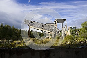 abandoned ruined building. concrete walls with broken windows and a lift, industrial buildings. victory of nature over