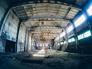 Abandoned ruined industrial factory building, corridor view with perspective, ruins and demolition concept