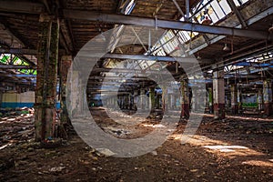 Abandoned ruined industrial warehouse or factory building inside, corridor view with perspective, ruins and demolition concept