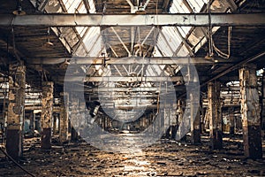 Abandoned ruined industrial warehouse or factory building inside, corridor view with perspective, ruins and demolition concept