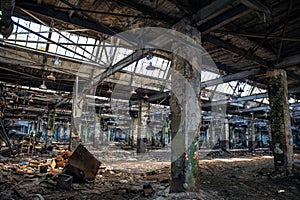 Abandoned ruined industrial warehouse or factory building inside, corridor view with perspective, ruins and demolition concept