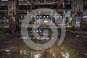 Abandoned ruined industrial warehouse or factory building inside, corridor view with perspective, ruins and demolition concept photo