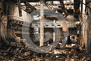 Abandoned ruined industrial warehouse or factory building inside, corridor view with perspective, ruins and demolition concept photo