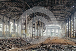 Abandoned ruined large industrial workshop in fogy day. Former Voronezh excavator manufacturing factory