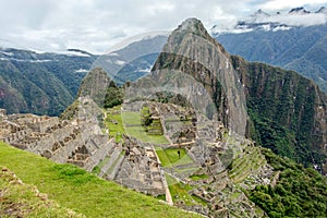 Abandoned ruins of Machu Picchu Incan citadel, the maze of terraces and walls rising out of the thick undergrowth, Peru