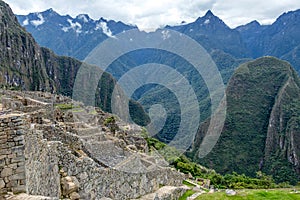 Abandoned ruins of Machu Picchu Incan citadel, the maze of terraces and walls rising out of the thick undergrowth, Peru