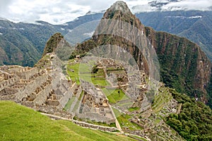 Abandoned ruins of Machu Picchu Incan citadel, the maze of terraces and walls rising out of the thick undergrowth, Peru