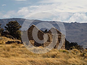 Abandoned run-down house ruins brick stone walls of goldmining settlement Welshtown Bendigo in Central Otago New Zealand