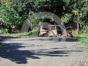 Abandoned rust damaged car in the jungle of Comoros island.