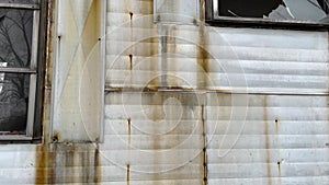 Abandoned rusted creepy mobile home with busted out windows