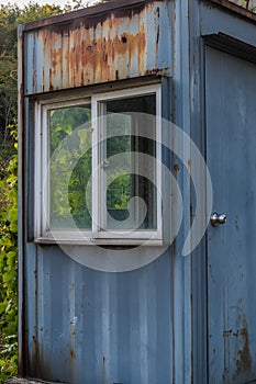 Abandoned rusted metal guardhouse