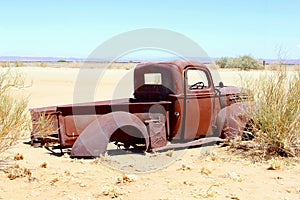 Abandoned rustic pickup car in desert, Africa