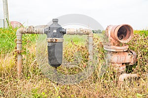 Abandoned Rustic Water Pipe and Water Filter in Field