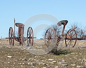 Abandoned, rusting vintage farm equipment in an open field