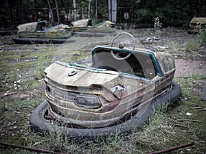 Abandoned rusty bumper cars aka dodgems, bumping cars, dodging cars, dashing cars in the Pripyat amusement park, Chernobyl