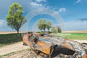 Abandoned rusty burnt car wreck,