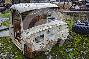 Abandoned rusty and forgotten cabin of an old truck. Junk transport of antique vehicles