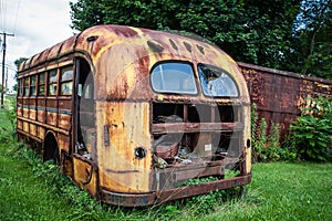 Abandoned rusty yellow school bus