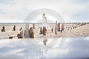 Abandoned salt production. Salt lane enclosed by dried wooden pillars on a salt lake. Adventure travel lifestyle concept.