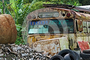 An abandoned schol bus rusts in a junkyard near Boqueue Panama