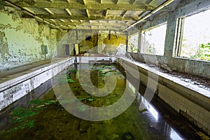 Abandoned school swimming pool in ghost town Pripyat Chornobyl Zone photo