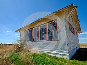 Abandoned schoolhouse remains standing in a farm field in southeastern Washington, USA