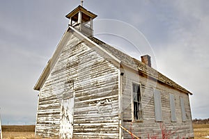 An abandoned Schoolhouse shows signs of age and deterioration.