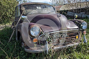Abandoned scrap vintage car. Bygone historic classic motor vehicle