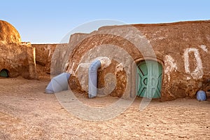 Abandoned set for the filming of Star Wars movie in the Sahara Desert against the backdrop of sand dunes.