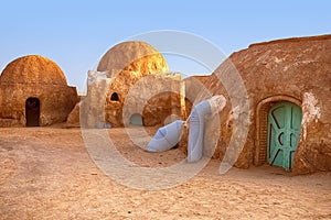 Abandoned set for the filming of Star Wars movie in the Sahara Desert against the backdrop of sand dunes.