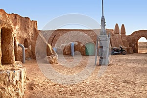Abandoned set for the filming of Star Wars movie in the Sahara Desert against the backdrop of sand dunes.