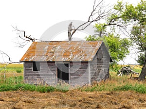 Abandoned shack in a prairie field
