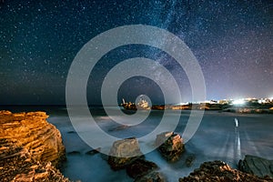 Abandoned ship Edro III near Cyprus beach at night.