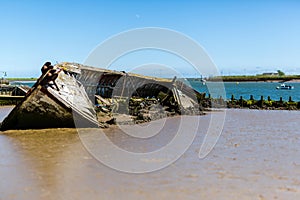 An abandoned ship wreak that is beached up on Orford beach in Suffolk