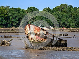 Abandoned Shipwrack on a Muddy Riverbank, Lanester-Kerhervy, Brittany photo
