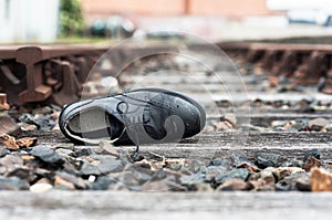 Abandoned shoe on train tracks