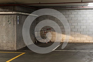Abandoned Shopping Cart Left in Dark Cover of Parking Garage