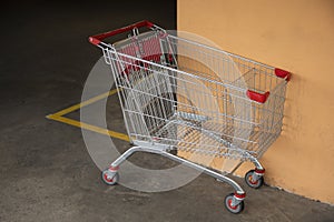 Abandoned Shopping Cart Reflecting Disorder in Parking Lot