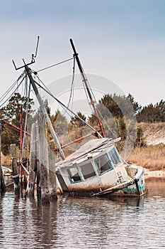 Abandoned shrimp boat half sunk photo
