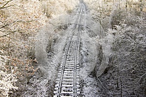 Abandoned single track railway line in sunny freezing weather