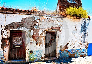 Abandoned Small House with Green Bush on Old Red Tile Roof