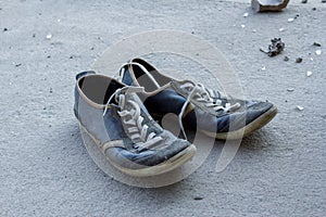 Abandoned sneakers on asphalt