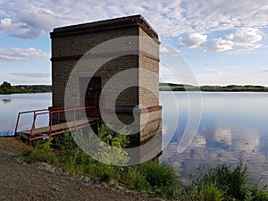 Abandoned stone building by the lake