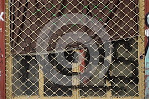 Abandoned storefront rolling gate dirty drape